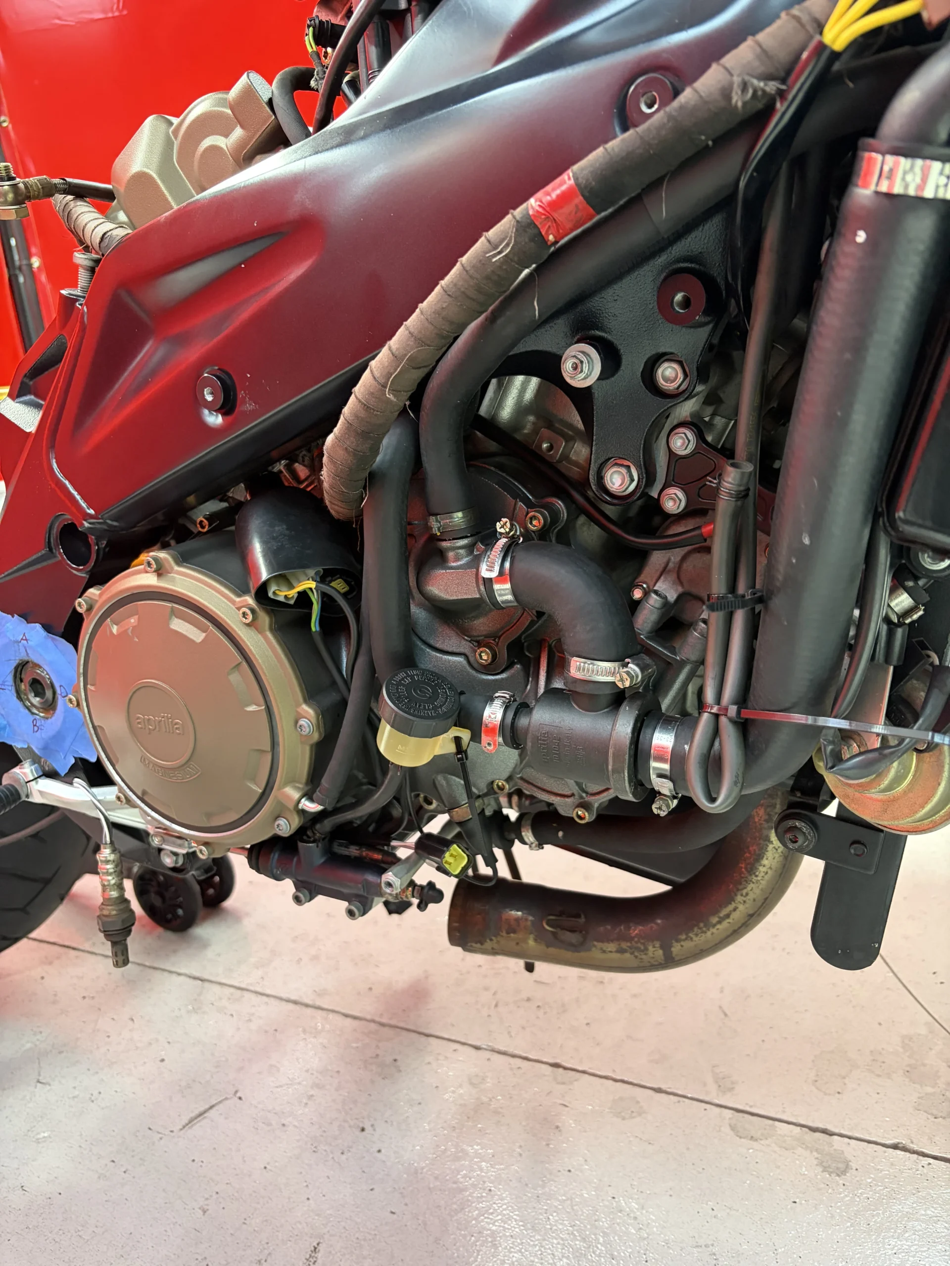 2005 Aprilia RSV1000R right-side cases, headers and hoses after dry ice blasting, clean alloy with decals and anodising intact