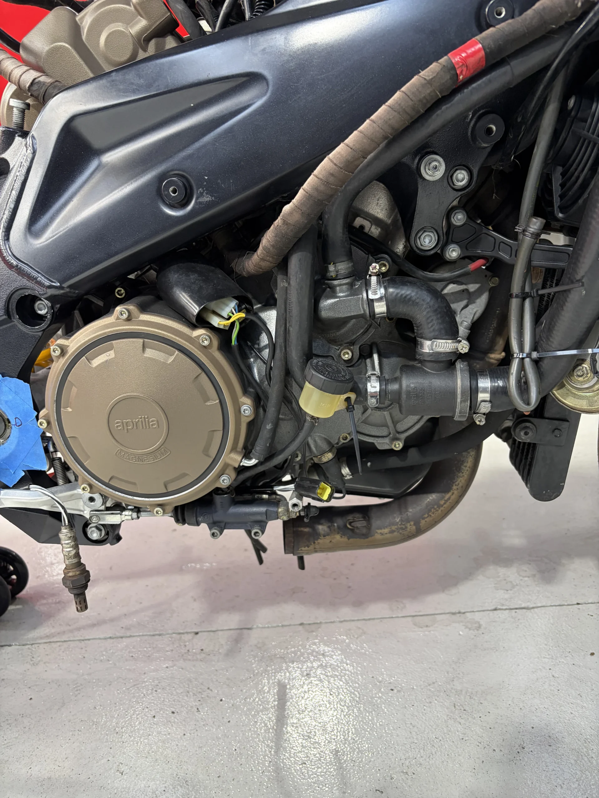 2005 Aprilia RSV1000R right-side engine cases and clutch cover before dry ice cleaning, covered in chain fling and baked-on oil mist