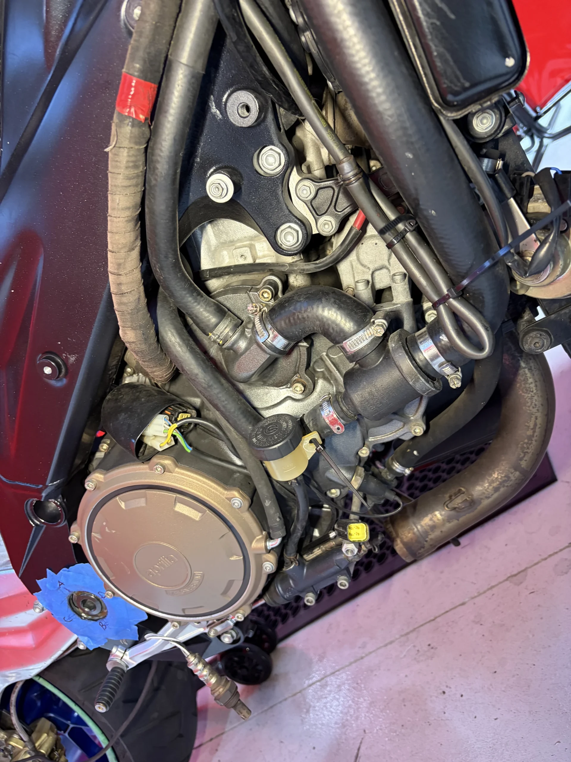 2005 Aprilia RSV1000R lower cases, headers and wiring before dry ice cleaning, covered in chain fling and baked-on oil mist