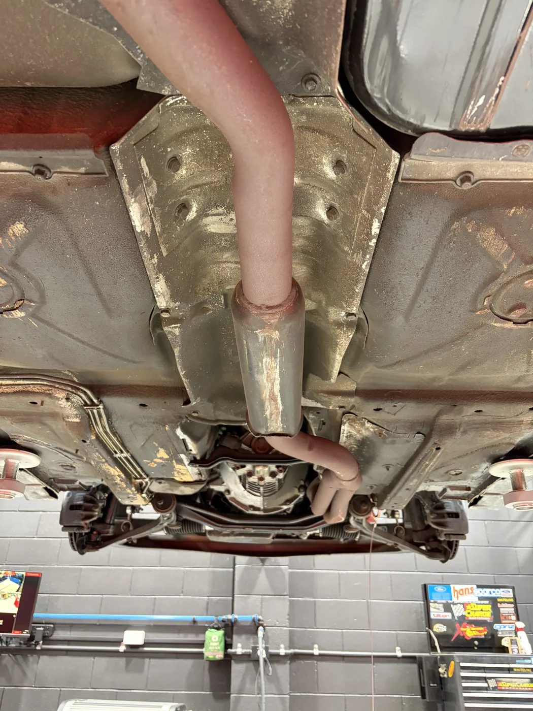 BMW E30 M-Tech 1 exhaust run and heat shields before dry ice cleaning, covered in road film and grime