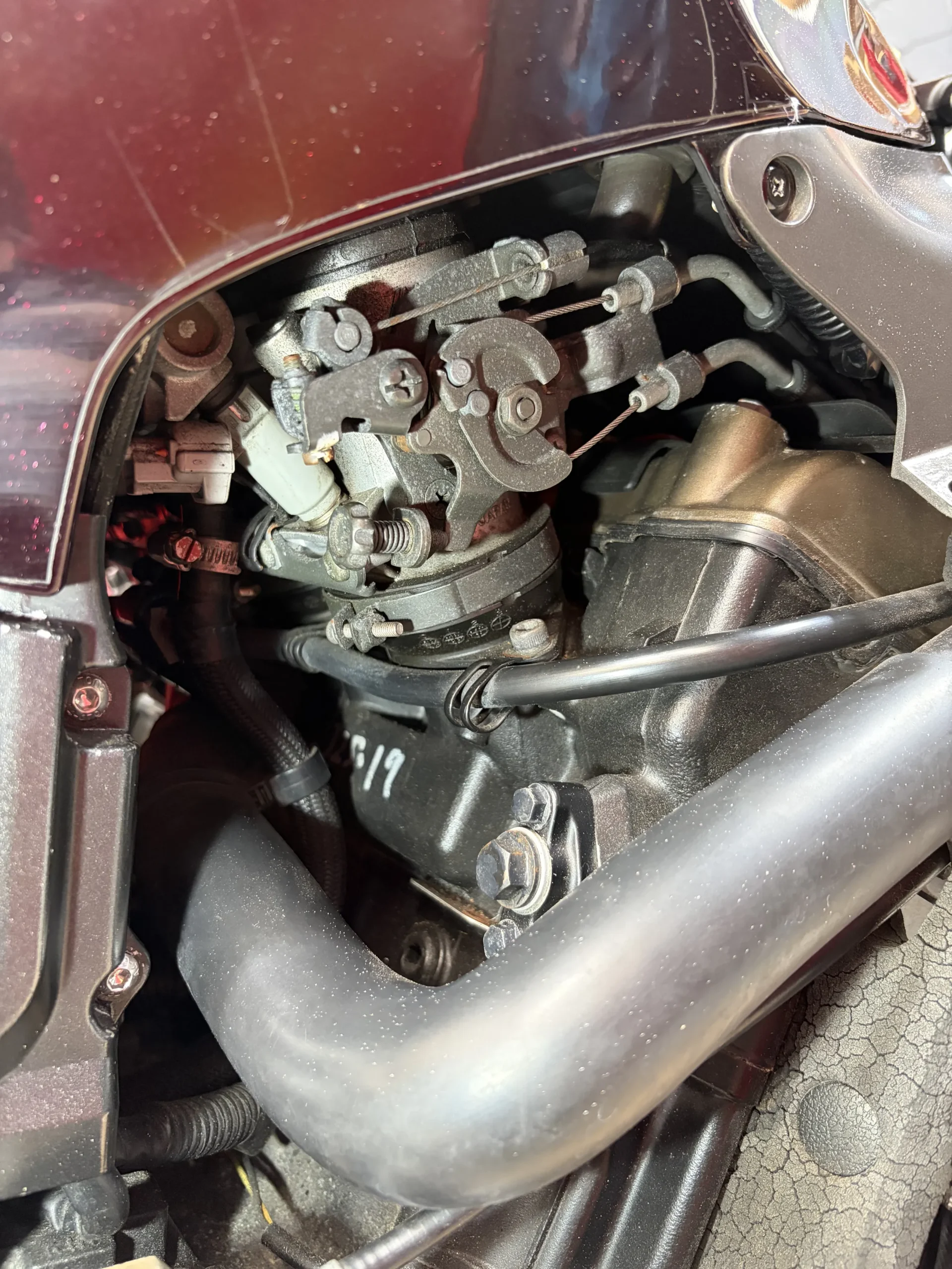 2004 Kawasaki ZX-12R throttle bodies and headers before dry ice cleaning, under road film and chain fling