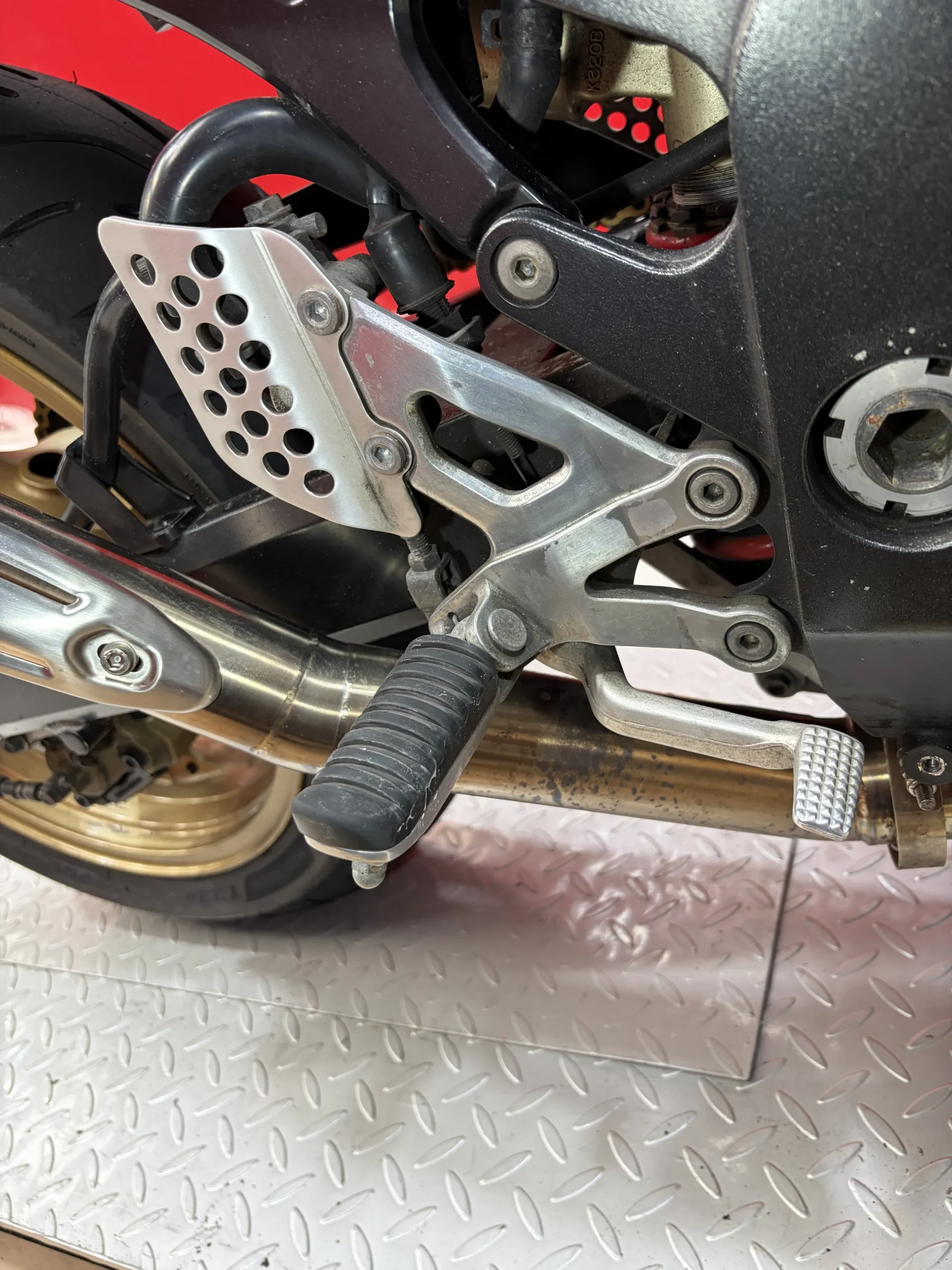 2004 Kawasaki ZX-12R rearsets, heel guard and exhaust before dry ice cleaning, under road film and chain fling